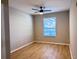 Bedroom featuring gray paint, wood floors, a ceiling fan, and a window with blinds at 3224 Dante Dr # 108, Orlando, FL 32835