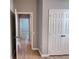 Hallway featuring neutral walls, modern flooring, doors, and natural light entering the space at 3224 Dante Dr # 108, Orlando, FL 32835