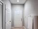 Bright hallway with a neutral color scheme, featuring tile flooring and white doors at 3224 Dante Dr # 108, Orlando, FL 32835