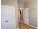 Hallway with view to archway, wood-look floors and double door closet at 3224 Dante Dr # 108, Orlando, FL 32835