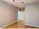 Living room showcasing wood floors, gray paint, and views into the kitchen and hallway at 3224 Dante Dr # 108, Orlando, FL 32835