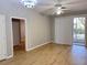 Living room showcasing wood floors, gray paint, sliding doors, and a ceiling fan at 3224 Dante Dr # 108, Orlando, FL 32835