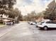 Covered parking with multiple parked cars under a partially cloudy sky at 3224 Dante Dr # 108, Orlando, FL 32835