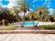 Palm trees stand alongside a community pool with lounge chairs for residents at 3224 Dante Dr # 108, Orlando, FL 32835