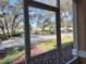 View from screened porch to grass and street at 3224 Dante Dr # 108, Orlando, FL 32835