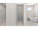 Bright bathroom featuring a soaking tub, toilet room, and access to walk-in closet at 13455 Sw 85 Pl, Dunnellon, FL 34432