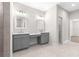 Modern bathroom featuring double vanity with gray cabinets and light countertops at 13455 Sw 85 Pl, Dunnellon, FL 34432