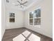 Bright bedroom featuring wood-look floors, a ceiling fan, and trim with white walls at 13455 Sw 85 Pl, Dunnellon, FL 34432