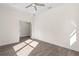 Bright bedroom featuring wood-look floors, a ceiling fan, and trim with white walls at 13455 Sw 85 Pl, Dunnellon, FL 34432