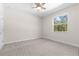 Bright bedroom featuring a large window and neutral colored carpet at 13455 Sw 85 Pl, Dunnellon, FL 34432