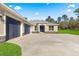 Three-car garage and front entrance of new home at 13455 Sw 85 Pl, Dunnellon, FL 34432