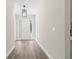 Bright foyer featuring wood flooring, a stylish light fixture, and a white front door with sidelights at 13455 Sw 85 Pl, Dunnellon, FL 34432
