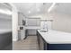 Bright kitchen with stainless steel appliances, white countertops and an island with blue base at 13455 Sw 85 Pl, Dunnellon, FL 34432