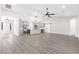 Spacious open-plan living room and kitchen with gray cabinets and luxury vinyl plank flooring at 13455 Sw 85 Pl, Dunnellon, FL 34432