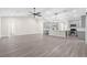 Bright open-plan living room with gray cabinets, a kitchen island, and light gray flooring at 13455 Sw 85 Pl, Dunnellon, FL 34432