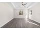 Bright, large main bedroom with a ceiling fan and light gray vinyl plank flooring at 13455 Sw 85 Pl, Dunnellon, FL 34432