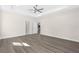 Large main bedroom with a tray ceiling, ceiling fan, and light gray vinyl plank flooring at 13455 Sw 85 Pl, Dunnellon, FL 34432