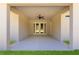 An empty outdoor patio features a ceiling fan and entry through glass paneled double doors at 13455 Sw 85 Pl, Dunnellon, FL 34432