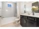 Bathroom features a white tiled shower and tub, toilet, granite vanity and a decorative flower vase at 10266 Beechwood Ln, Orlando, FL 32832