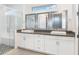 Bathroom featuring double sinks, a glass-enclosed shower with seat, and modern fixtures at 10266 Beechwood Ln, Orlando, FL 32832