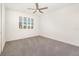 Bedroom with plush carpeting, white walls, a window with shutters and a ceiling fan at 10266 Beechwood Ln, Orlando, FL 32832