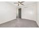 This bedroom features neutral walls, carpet flooring, ceiling fan, and a closet with white sliding doors at 10266 Beechwood Ln, Orlando, FL 32832