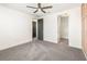Bedroom with plush carpeting, white walls, two doors and a ceiling fan at 10266 Beechwood Ln, Orlando, FL 32832