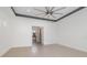 Large bedroom with ceiling fan and transom window over entry, tile floors and view to bath area at 10266 Beechwood Ln, Orlando, FL 32832