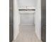 Bright hallway with tile floors leading to a room with a closed shuttered sliding glass door at 10266 Beechwood Ln, Orlando, FL 32832