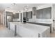 Modern kitchen features a large island, stainless steel appliances and elegant gray cabinetry at 10266 Beechwood Ln, Orlando, FL 32832