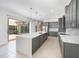 Spacious kitchen featuring stainless appliances, a large island and sliding doors to the outside at 10266 Beechwood Ln, Orlando, FL 32832