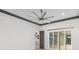 Spacious living room with a ceiling fan and sliding glass doors to the outside at 10266 Beechwood Ln, Orlando, FL 32832