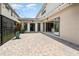 Rear patio area featuring pavers and view of covered area and kitchen at 10266 Beechwood Ln, Orlando, FL 32832