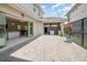 Paver patio area with view of covered area and kitchen seen through sliding glass door at 10266 Beechwood Ln, Orlando, FL 32832