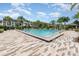 Large community pool with ample seating surrounded by lush landscaping at 10266 Beechwood Ln, Orlando, FL 32832