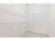 Walk-in closet featuring metal shelving and tile floors at 10266 Beechwood Ln, Orlando, FL 32832