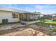 View of the backyard featuring a screened-in patio and a partially fenced-in yard at 2495 Sedgefield Ave, Deltona, FL 32725