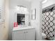 Bright bathroom featuring a white vanity with modern fixtures and a shower with patterned curtain at 2495 Sedgefield Ave, Deltona, FL 32725