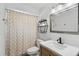 Bathroom featuring a modern vanity, framed mirror, toilet, and shower with patterned curtain at 2495 Sedgefield Ave, Deltona, FL 32725