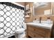 Neutral tone bathroom with geometric shower curtain, mirror and light wood vanity at 2495 Sedgefield Ave, Deltona, FL 32725