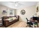 Cozy bedroom featuring wood floors, a ceiling fan, and a spacious window at 2495 Sedgefield Ave, Deltona, FL 32725
