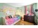 Colorful bedroom with a light green wall, bed, window and dresser at 2495 Sedgefield Ave, Deltona, FL 32725