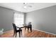 Inviting dining room featuring a ceiling fan, grey walls, and a dark wood table set for two at 2495 Sedgefield Ave, Deltona, FL 32725