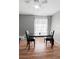 Inviting dining room featuring a ceiling fan, grey walls, and a dark wood table set for two at 2495 Sedgefield Ave, Deltona, FL 32725