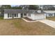 White single-story house with attached garage and landscaping at 2495 Sedgefield Ave, Deltona, FL 32725