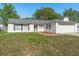 Charming single-story home with white siding, dark shutters, and a well-maintained front yard at 2495 Sedgefield Ave, Deltona, FL 32725