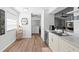 Bright kitchen featuring white cabinets, stainless steel appliances, and view into living area at 2495 Sedgefield Ave, Deltona, FL 32725