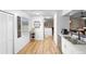 Clean and bright kitchen with white cabinets, double sink, and wood floor at 2495 Sedgefield Ave, Deltona, FL 32725