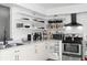 Stylish kitchen with white cabinetry, open shelving, stainless steel appliances, and modern finishes at 2495 Sedgefield Ave, Deltona, FL 32725