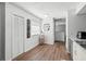 Cozy kitchen and dining area featuring wood floors, window, closet door and welcoming decor at 2495 Sedgefield Ave, Deltona, FL 32725